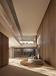 Hall de entrada do Mansa revestido em madeira, com iluminação quente e poltrona clara.